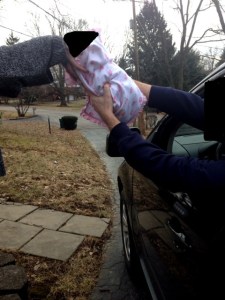 A client hands his infant over to a SunnyTimes employee at the controversial drive-thru 